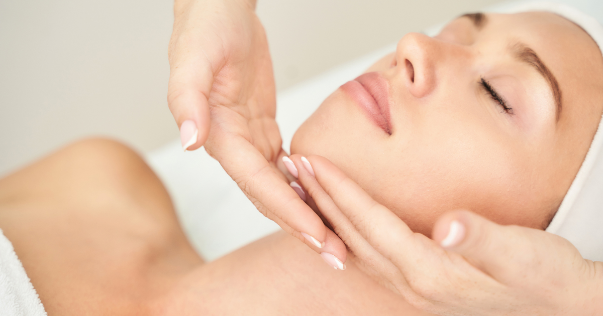 Esthetician performing a relaxing facial treatment at Glow Facial Bar.